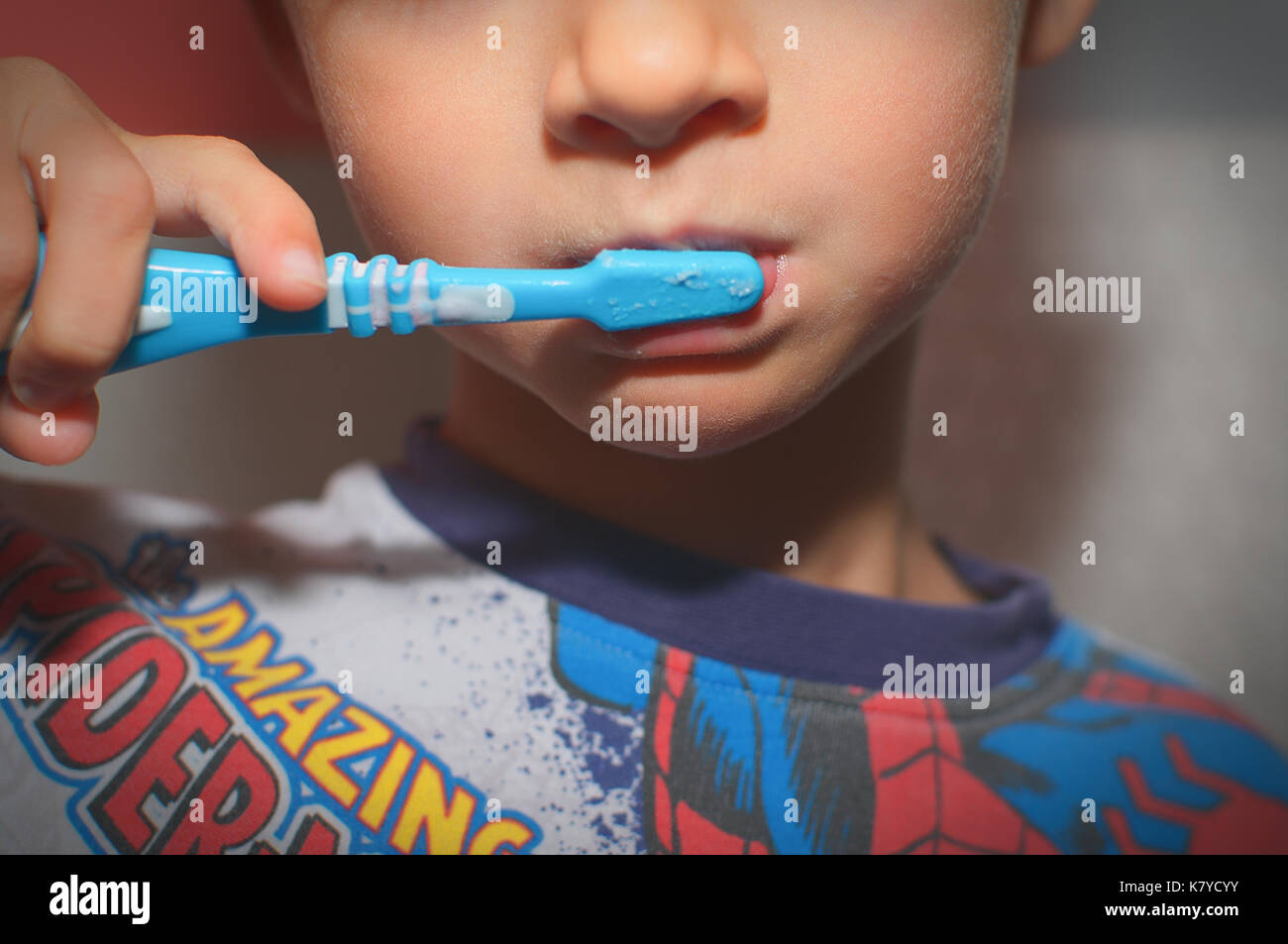 Little boy in pyjamas brushing his teeth Stock Photo