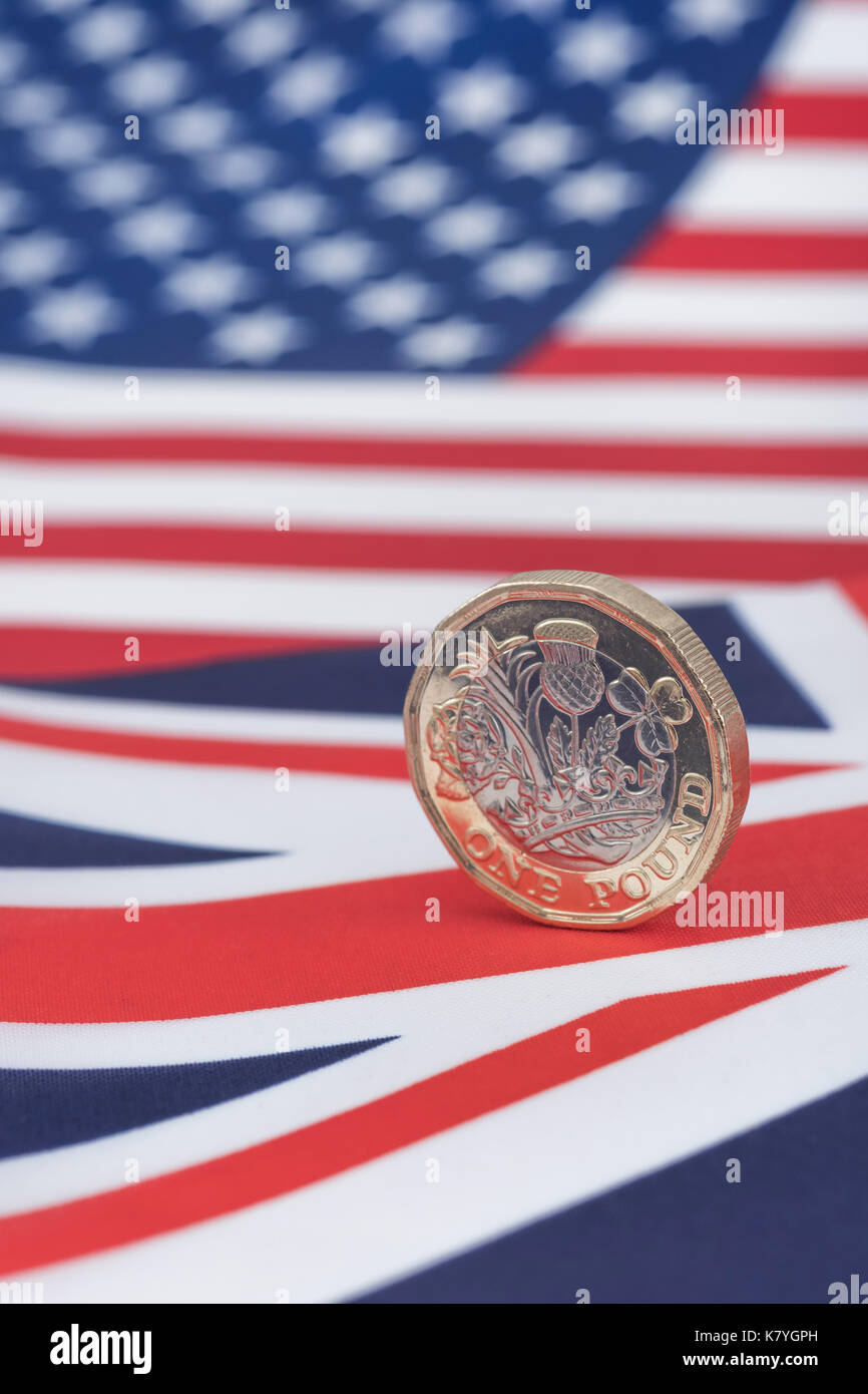 US and UK Union Jack with new UK £1 / Pound coin - as metaphor for US-British trade and currency exchange rate. Stock Photo