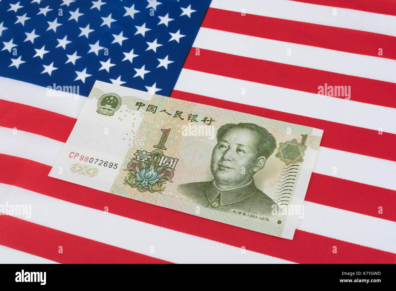 Stars and Stripes flag + Chinese 1 Yuan banknote- metaphor for Dollar-Renminbi exchange rate, US-China trade deficit, tariff war, US-China trade war Stock Photo