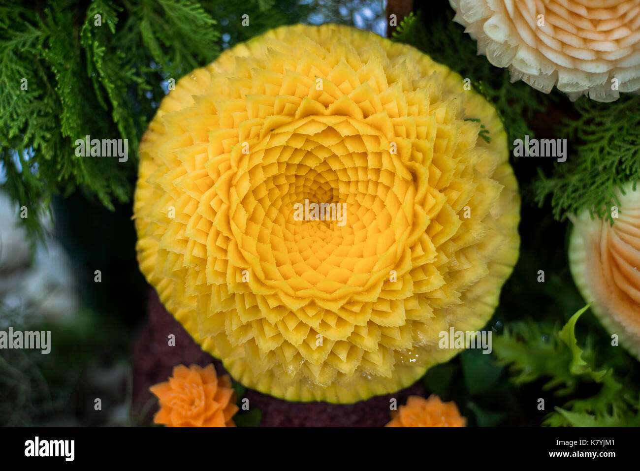 Thai fruit carving is a traditional Thai art that requires neatness, precision, meditation, and personal ability. Fruit carving persisted in Thailand  Stock Photo