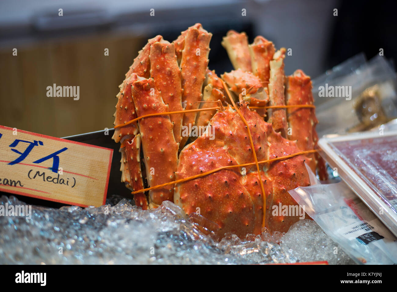 King crab displayed in a fresh market with Japanese sign. Stock Photo