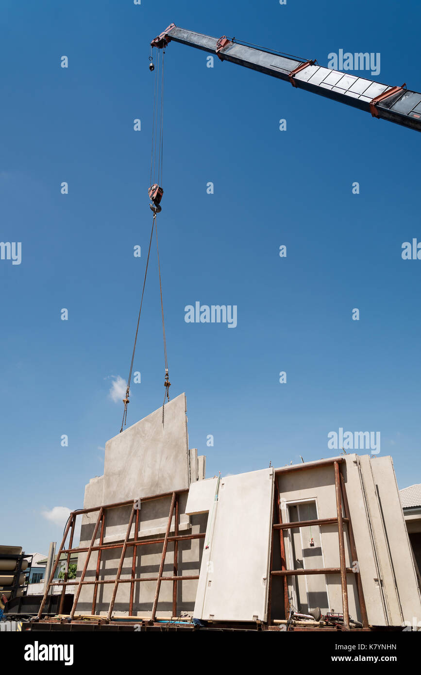 Construction crane lifting precast concrete hires stock photography