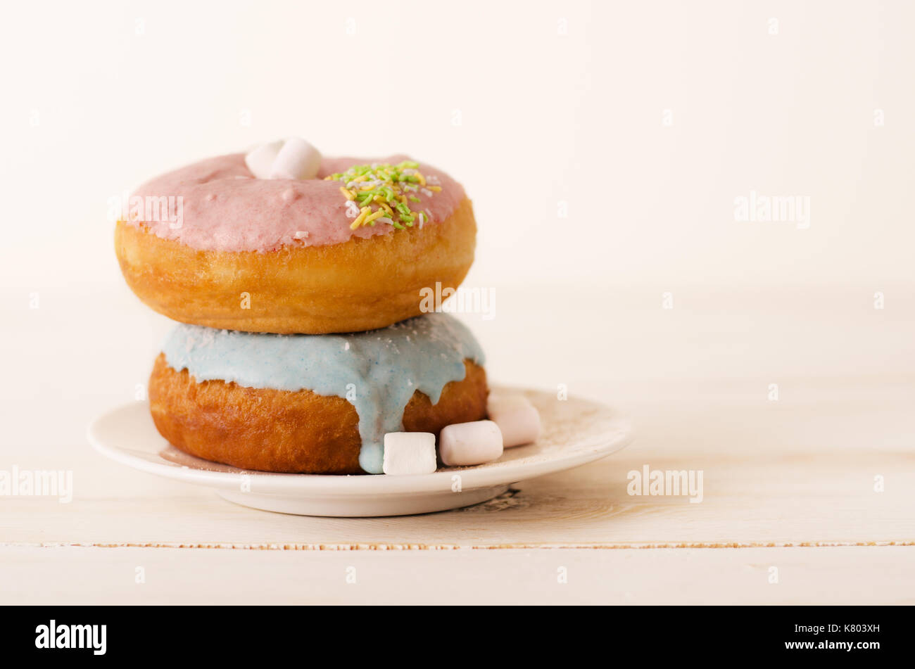 Pair of glazed donuts on white background Stock Photo - Alamy