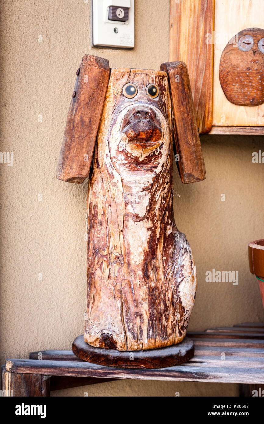Japan, Kanazawa. Wooden figure of dog, hound, standing outside hand carved woodcraft store. Stock Photo