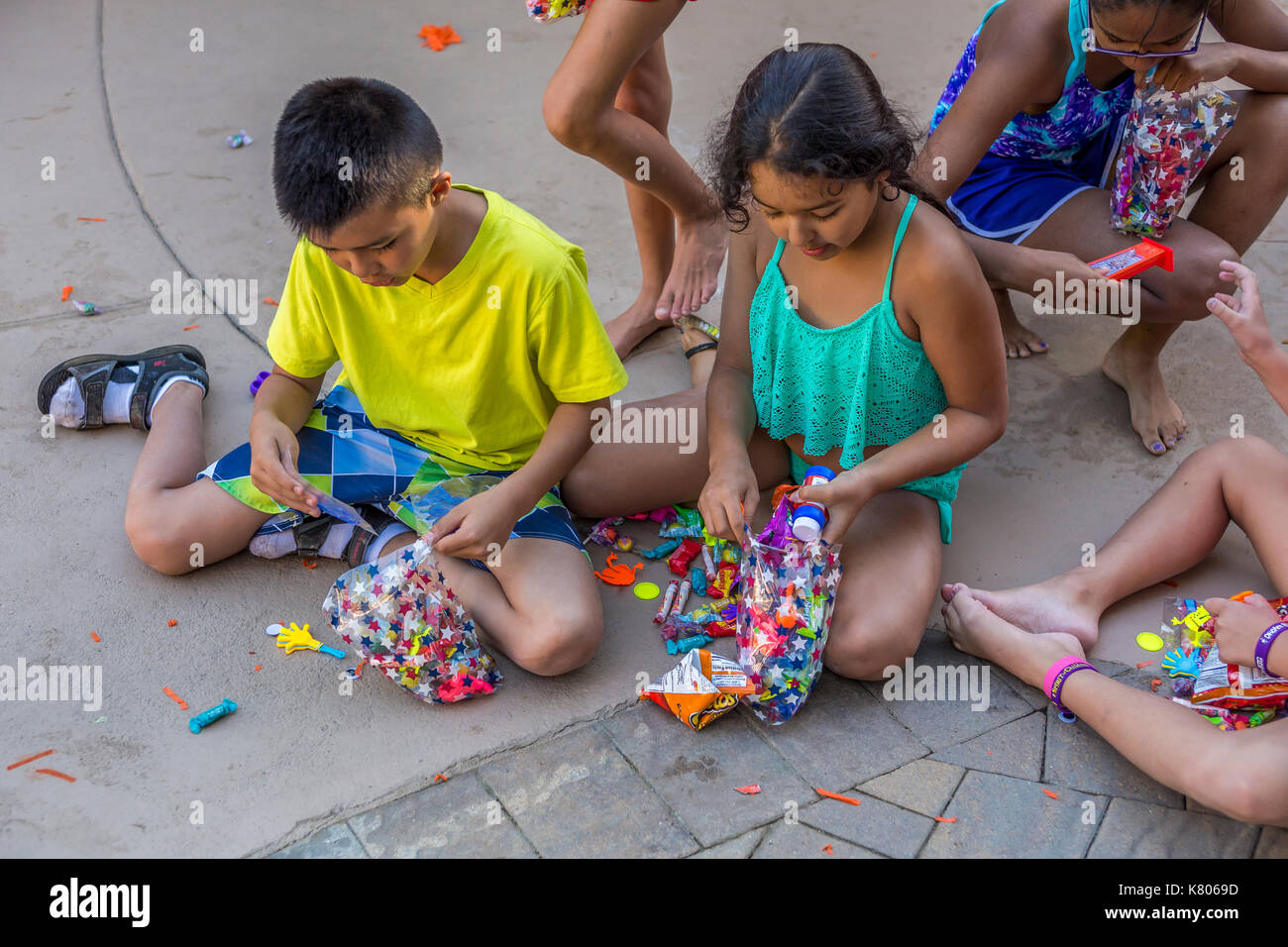 children collecting pinata candy, pinata candies, pinata sweets, pinata toys, Castro Valley, Alameda County, California, United States Stock Photo