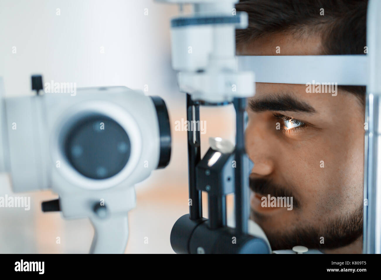 Patient or customer at slit lamp at optometrist or optician Stock Photo