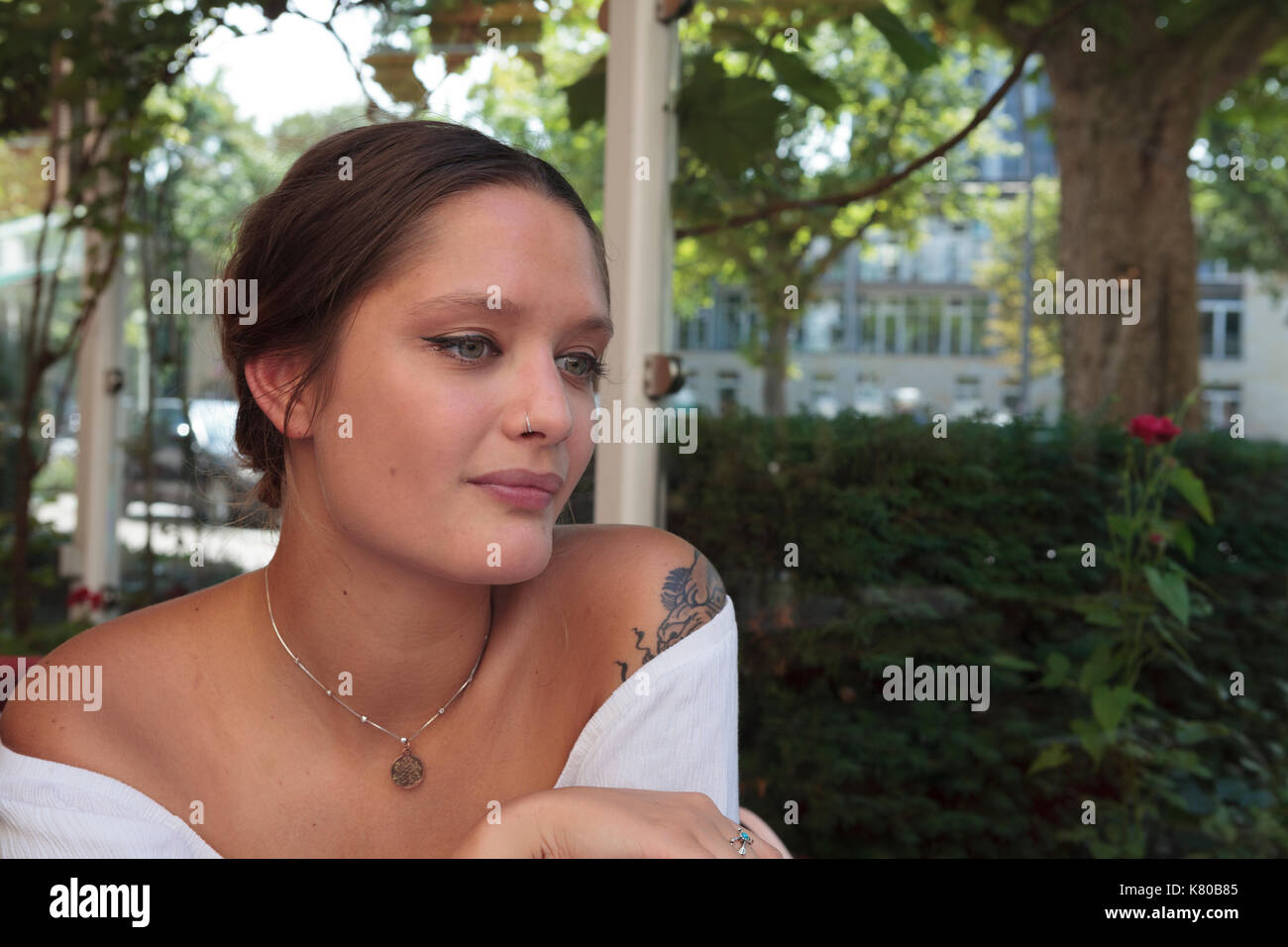 Young woman smiling while looking away from camera Stock Photo