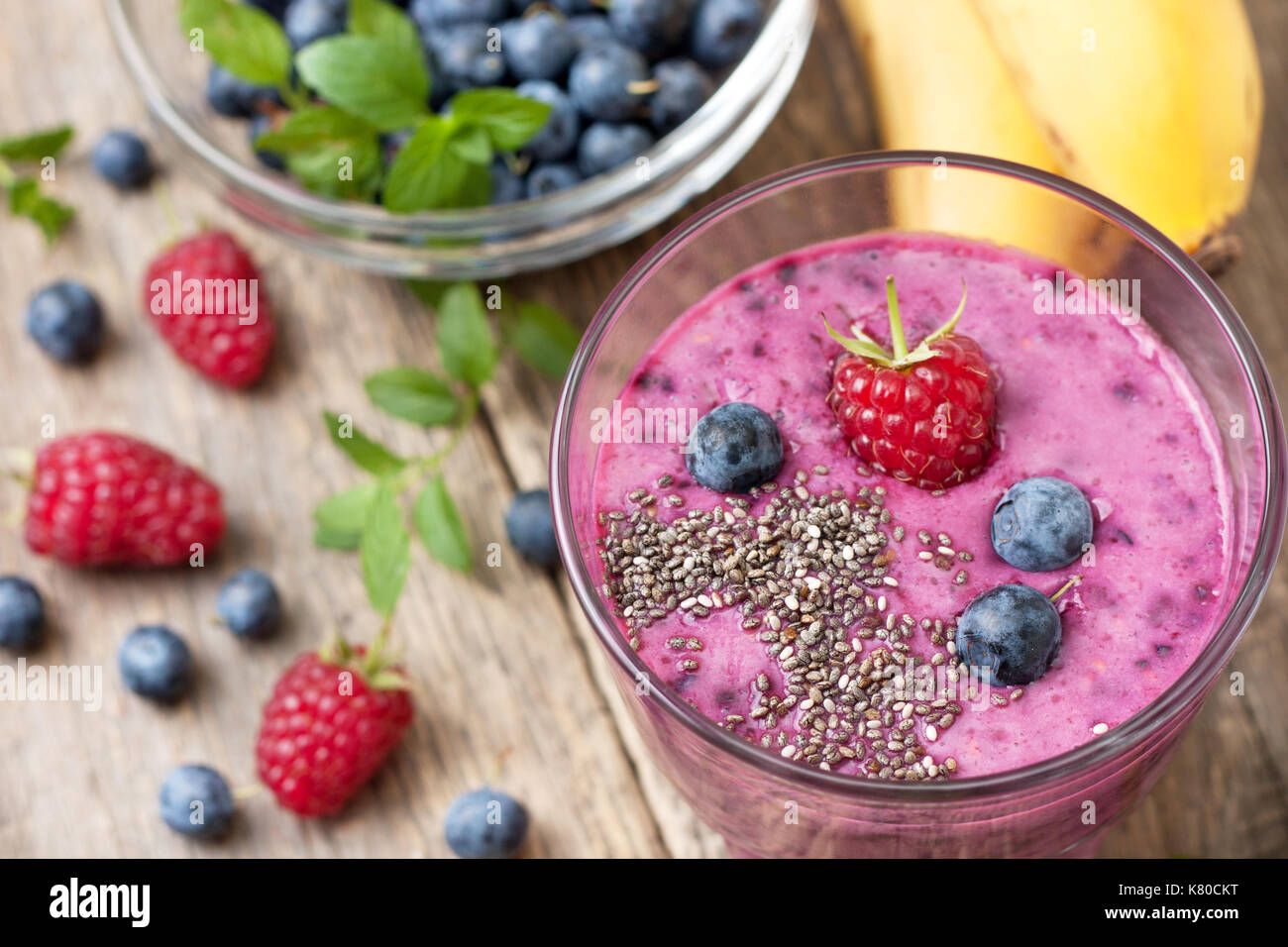 smoothie with blueberries and raspberries, chia seeds in a glass, fresh ...