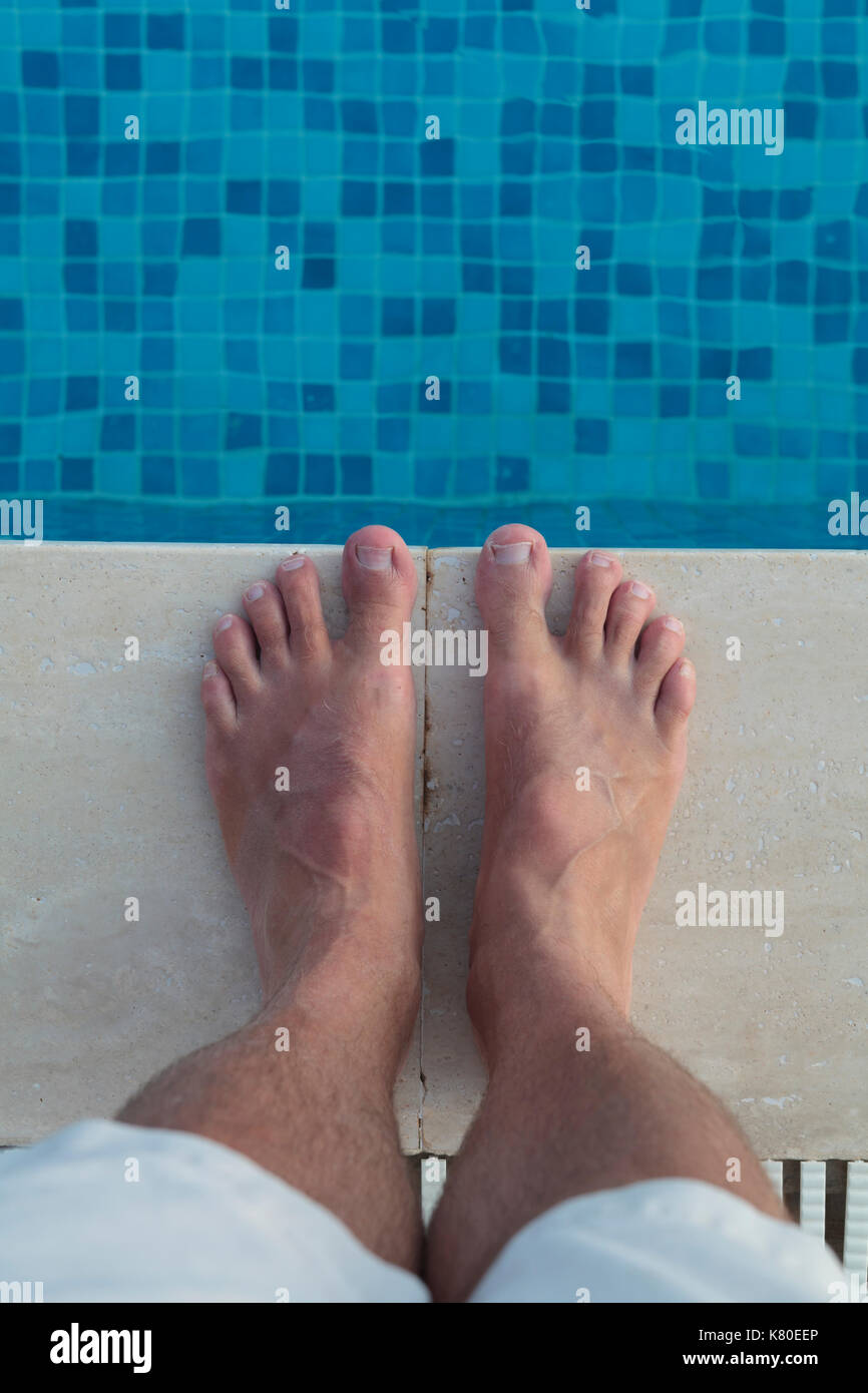 Feet standing by side of swimming pool Stock Photo - Alamy