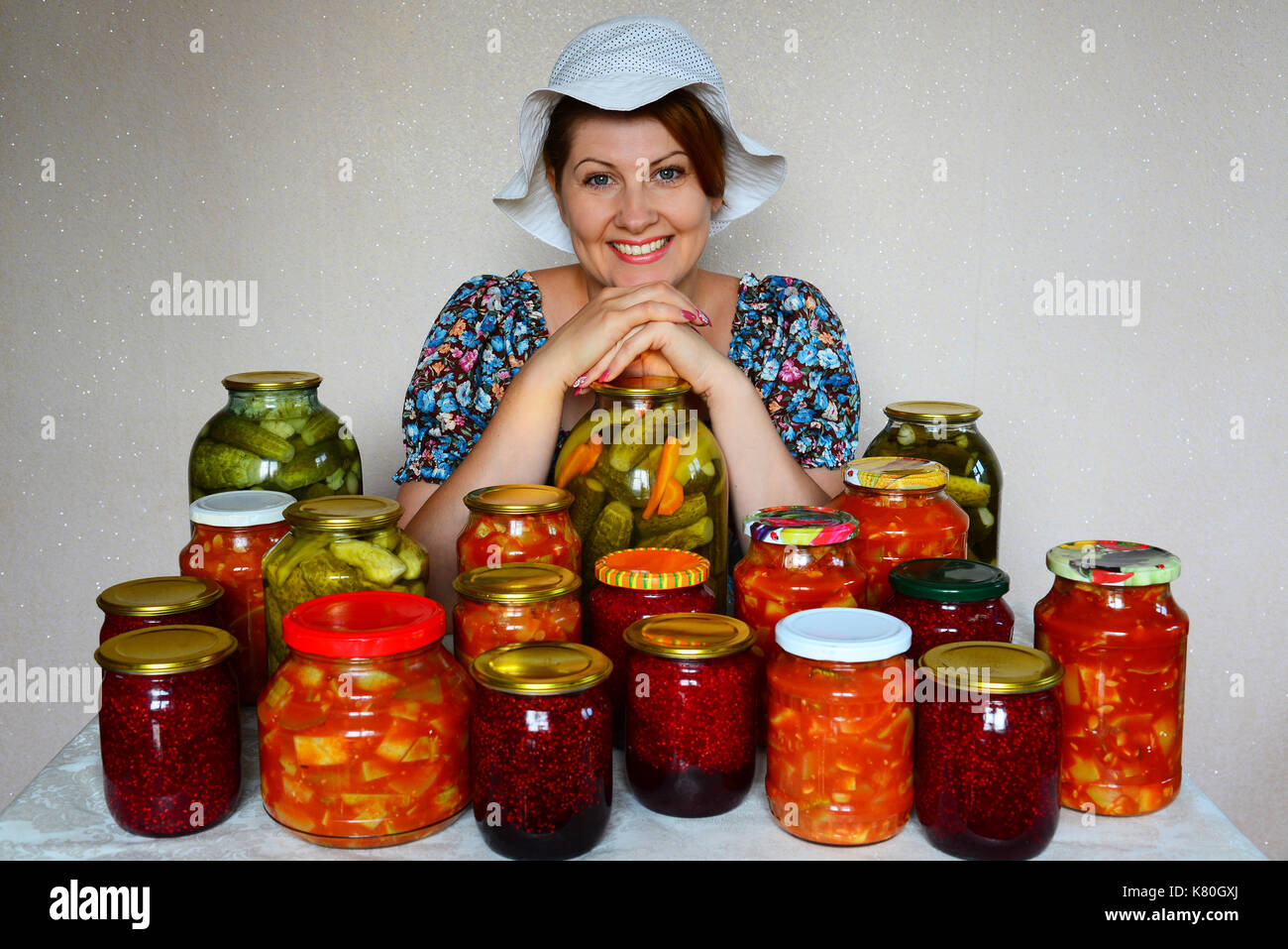 Happy housewife with homemade canned food Stock Photo