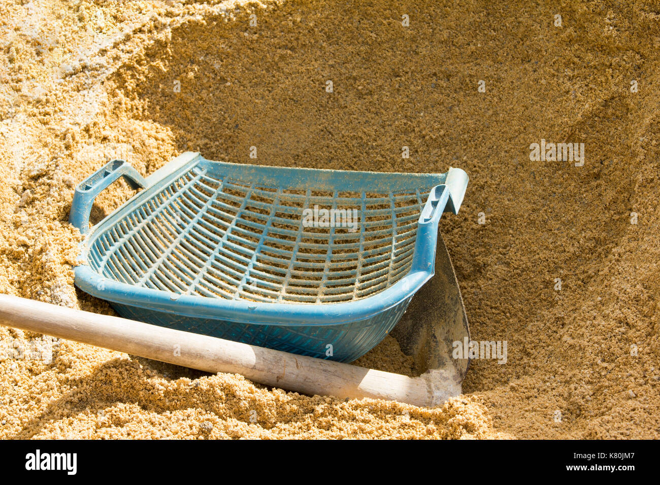 Spades and buckets on Sand pile for construction Stock Photo Alamy