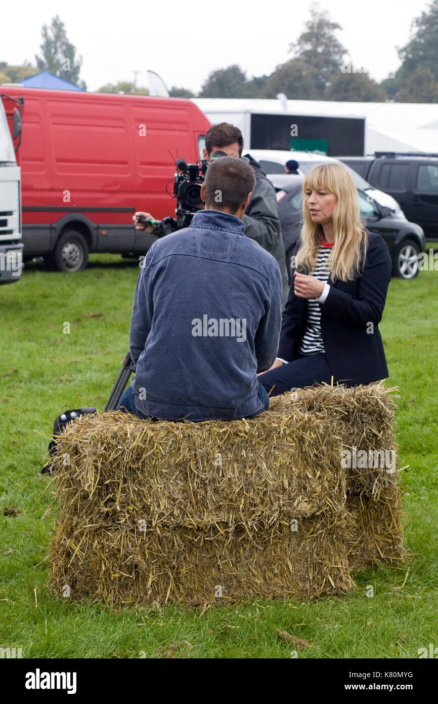 Sarah cox interviewing sitting on hay bales Stock Photo