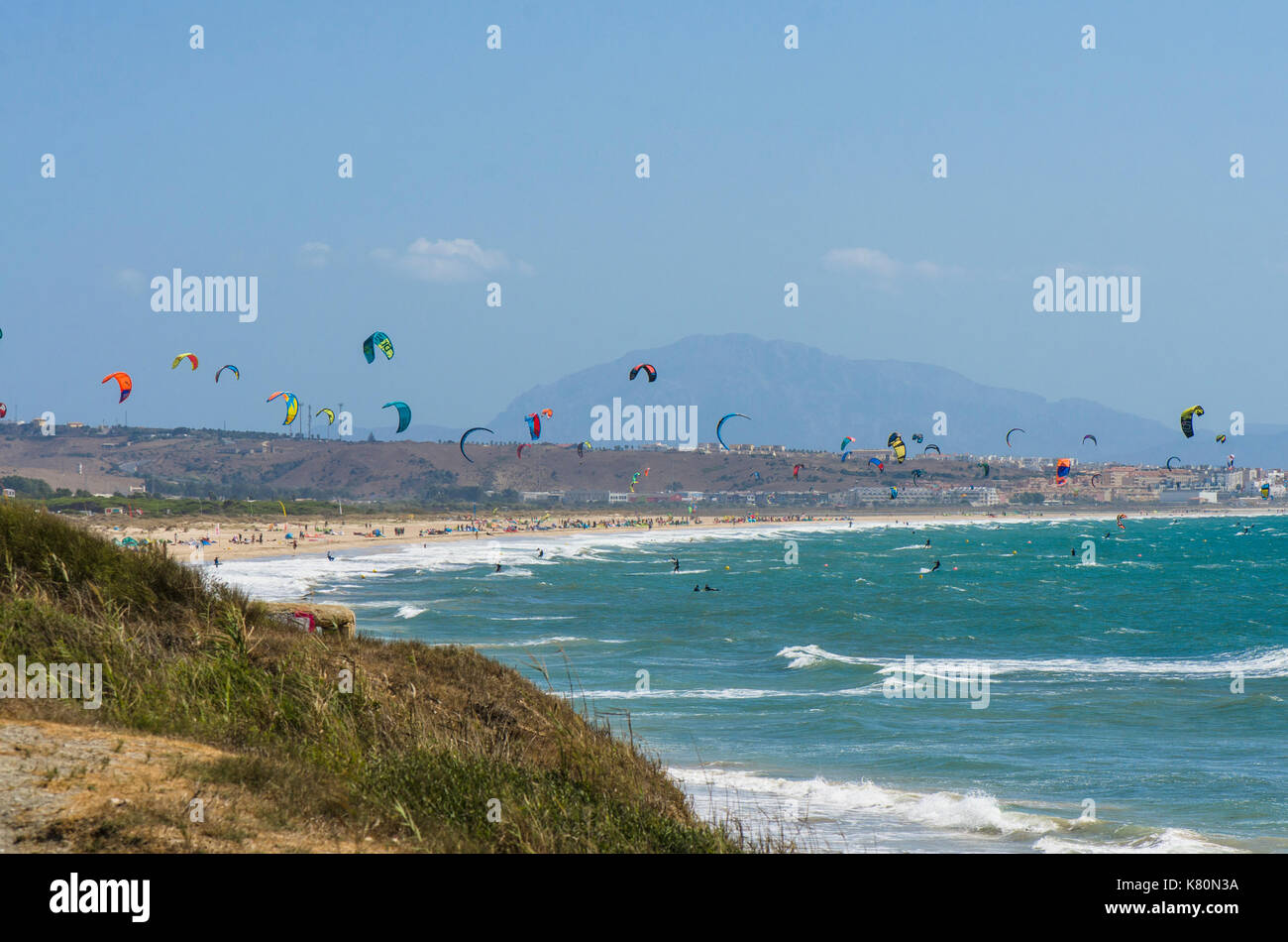 Kitesurfers and windsurfers on the beach at Ensenada de Bolonia, Costa de la Luz, Tarifa, Spain Stock Photo