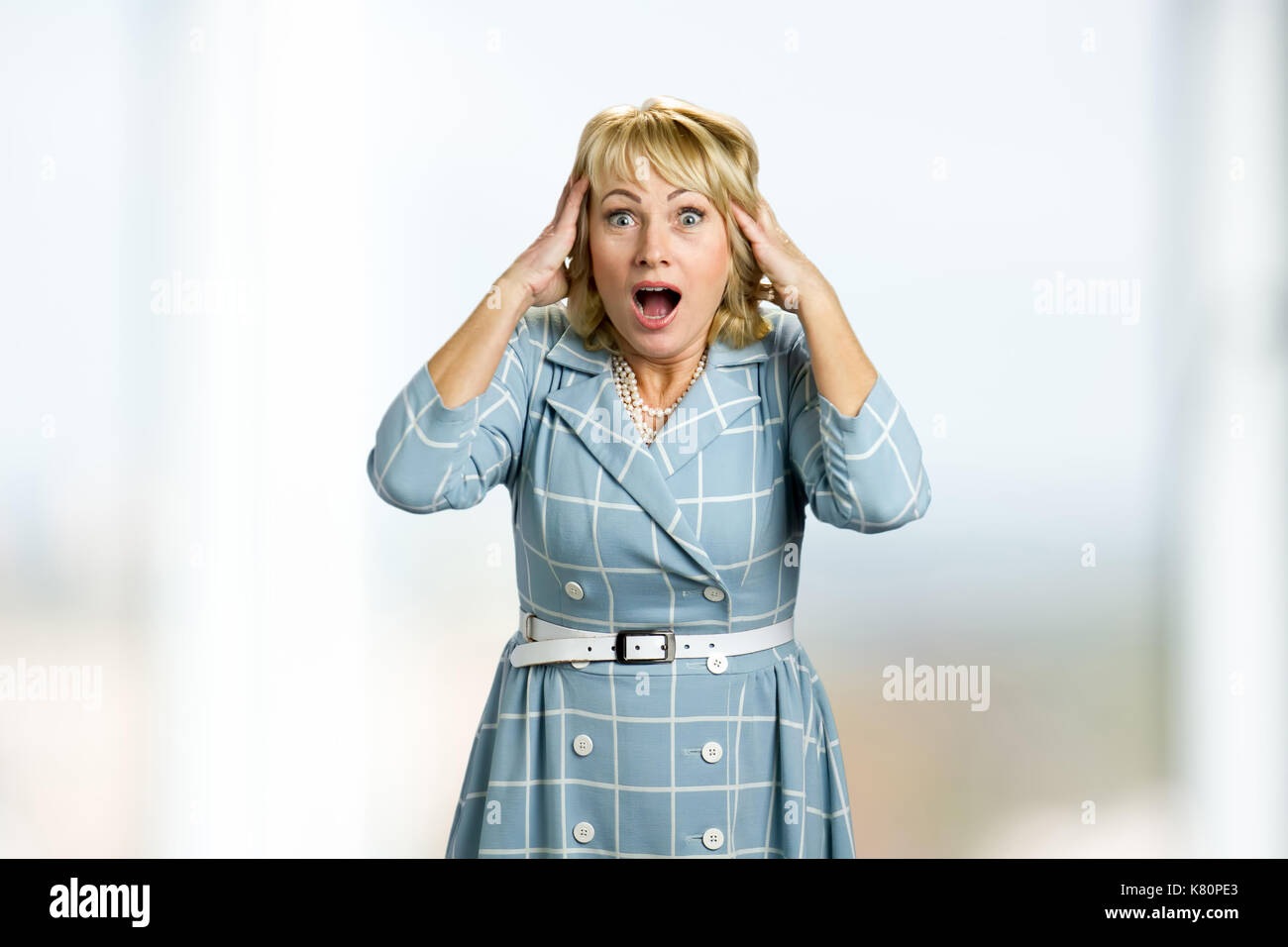 Surprised mature woman open mouth. Stock Photo