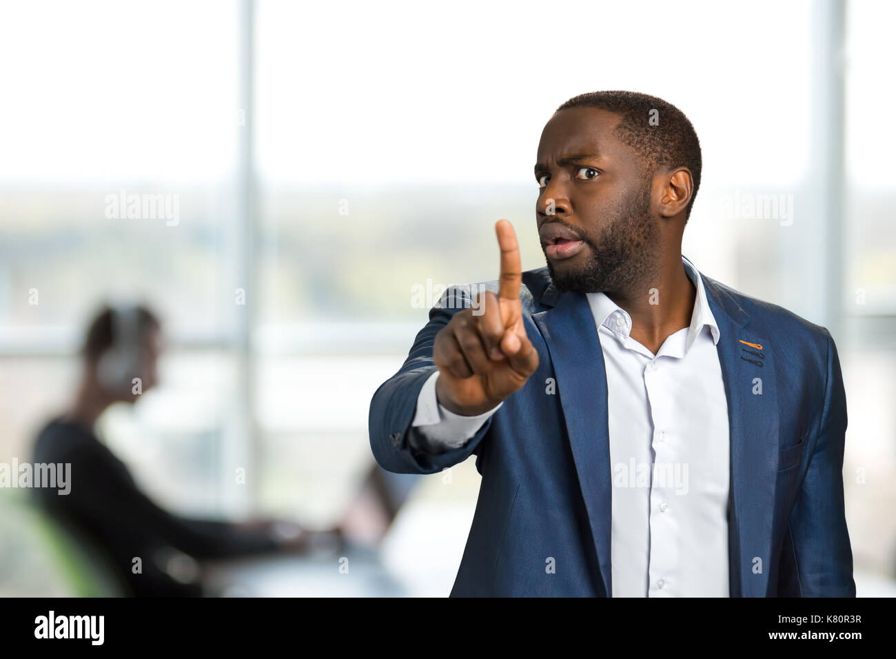 Businessman pointing his finger towards camera. Stock Photo