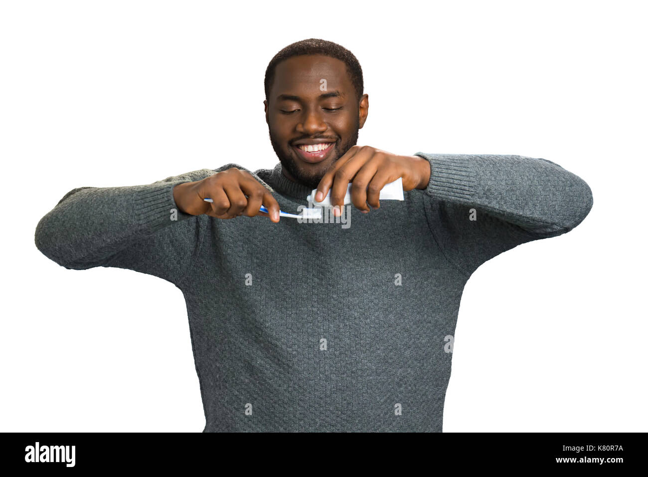 Black man applying toothpaste on a toothbrush Stock Photo Alamy