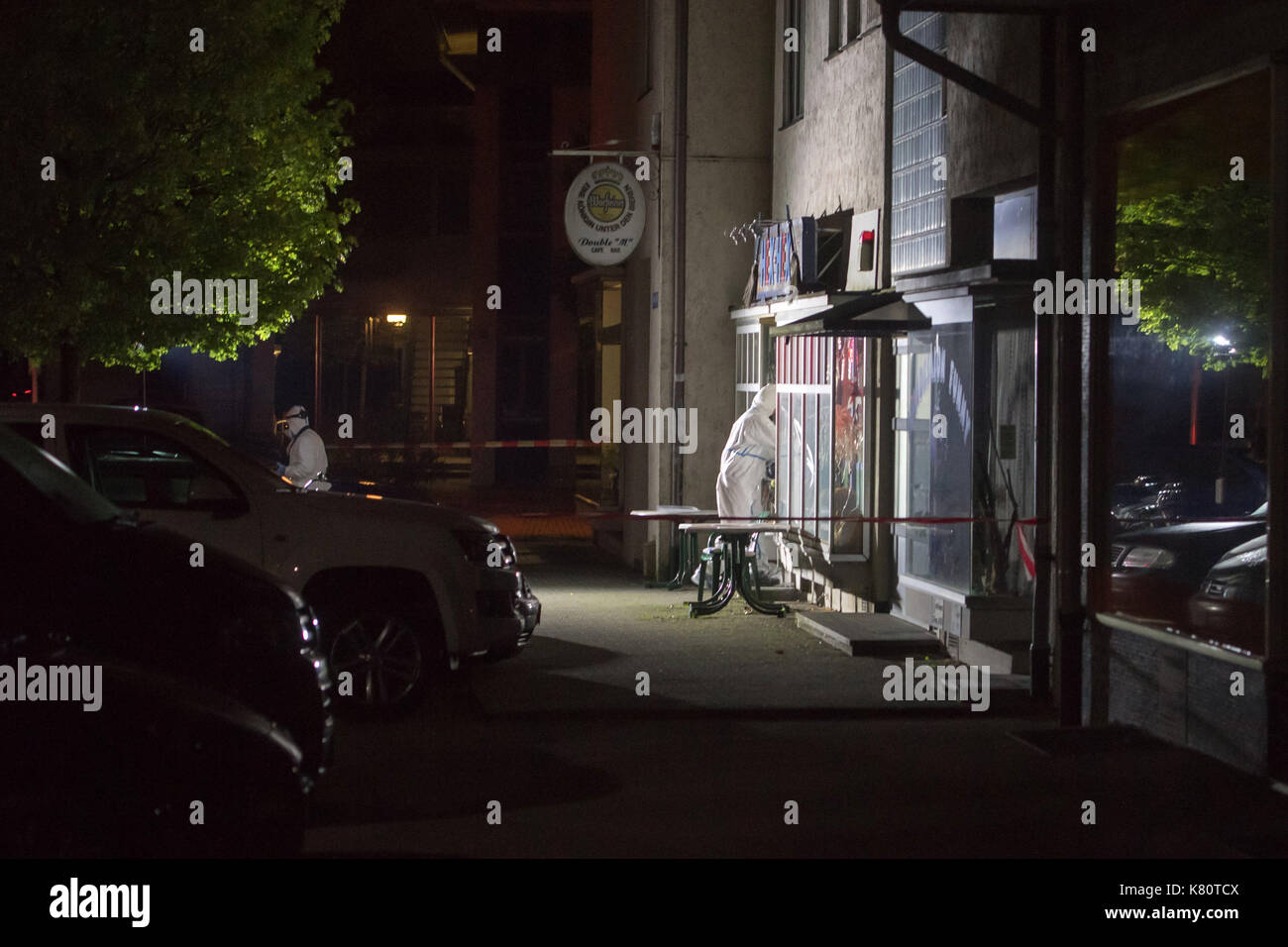 Traunreut, Germany. 17th Sep, 2017. Police crime scene investigators enter a bar in Traunreut, Germany, 17 September 2017. A man opened fire in a bar, leaving two dead and two severely injured. Photo: Tobias Hase/dpa/Alamy Live News Stock Photo