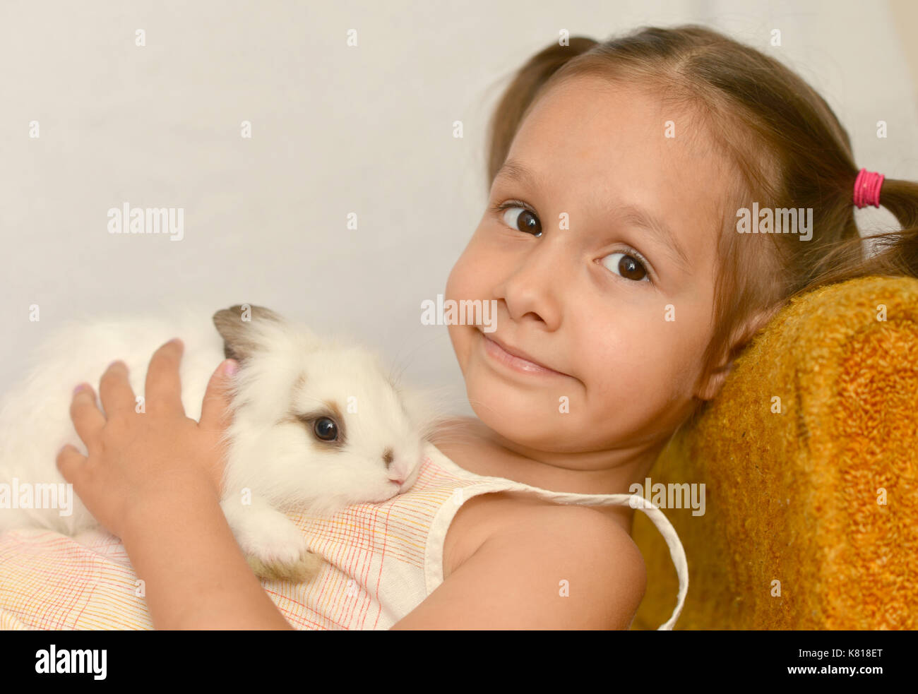 little girl holding small rabbit Stock Photo - Alamy