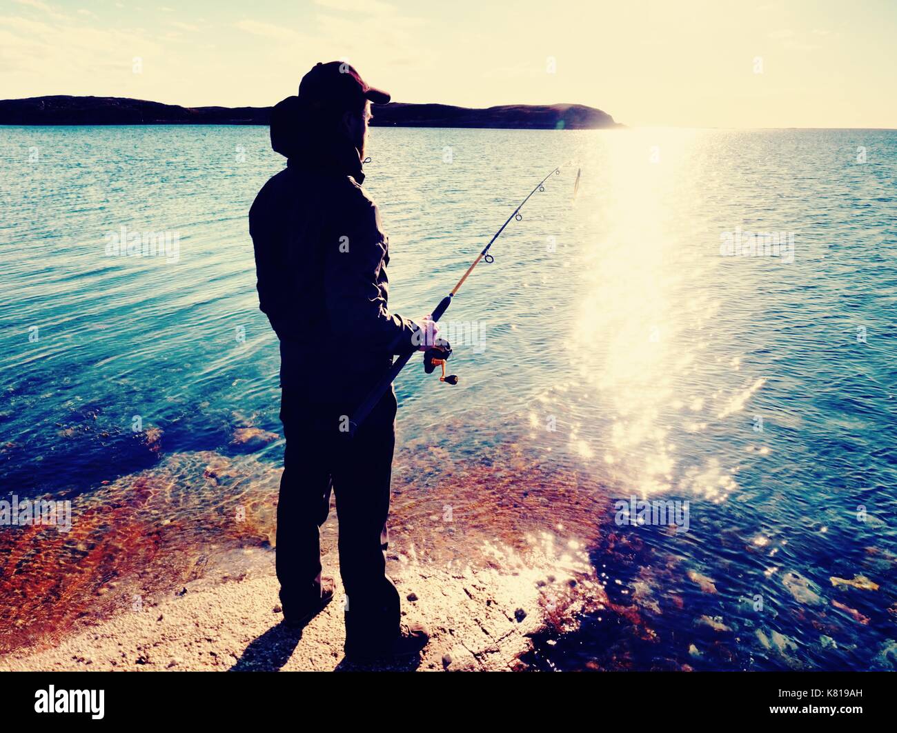 Fisherman check fishing line and pushing bait on the rod, prepare