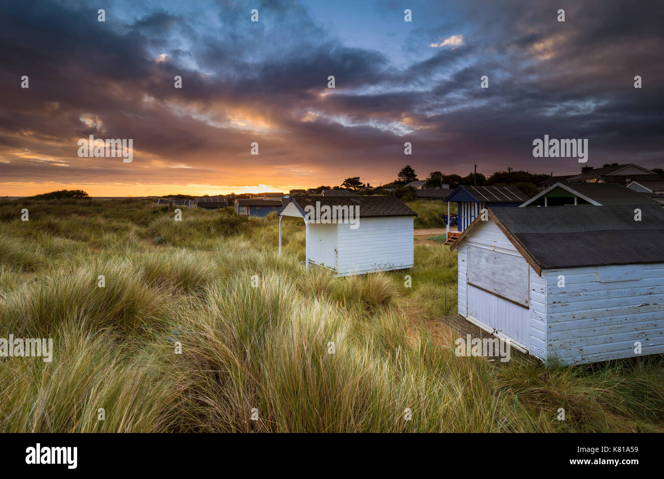 Beach huts amonst the grassy dunes at Old Hunstanton. Stock Photo