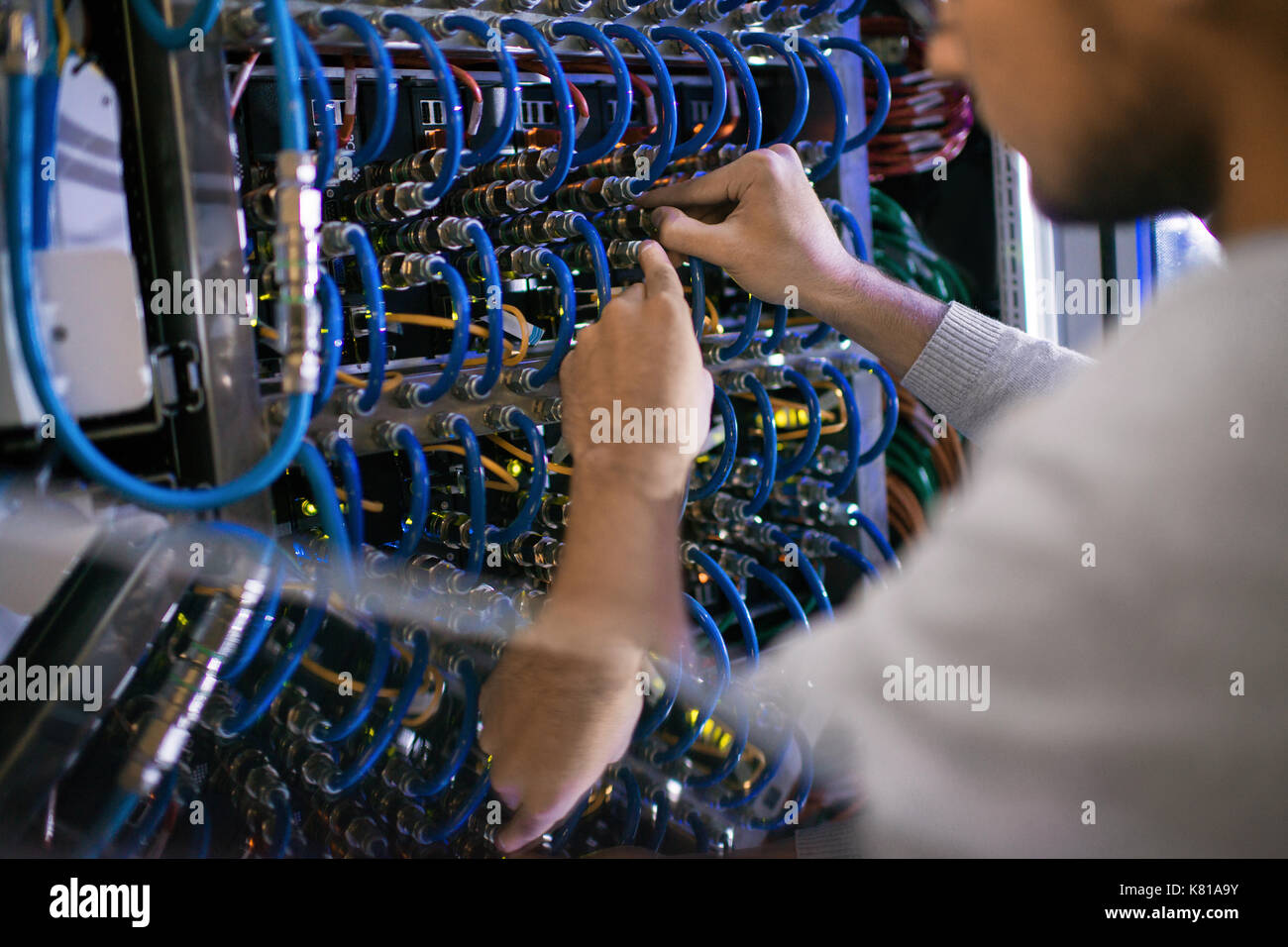 Man Working with Server Cabinet Stock Photo