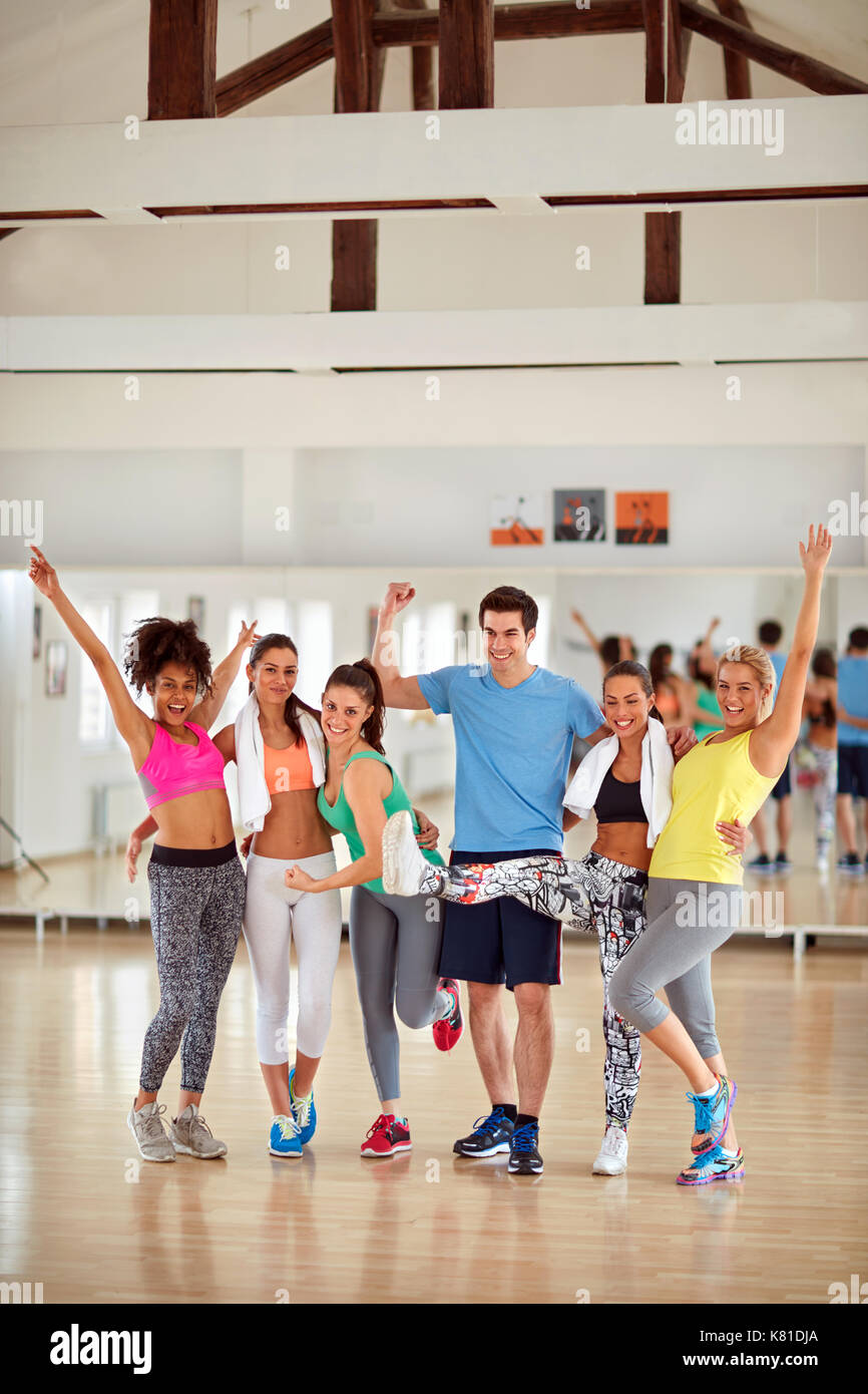 Group photo of joyful young people after fitness training in gym Stock Photo