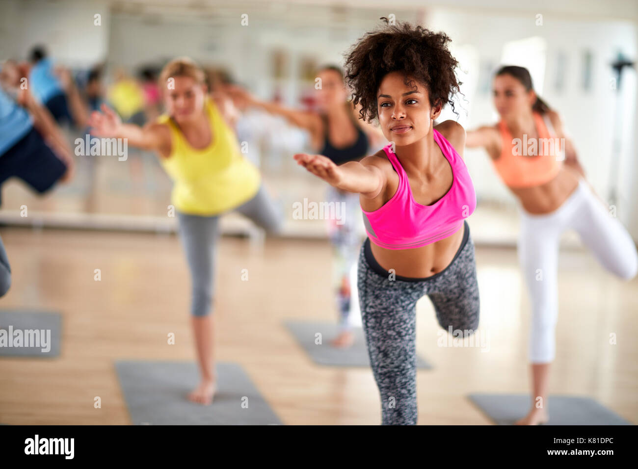 Black curly girl on body balance training at gym Stock Photo