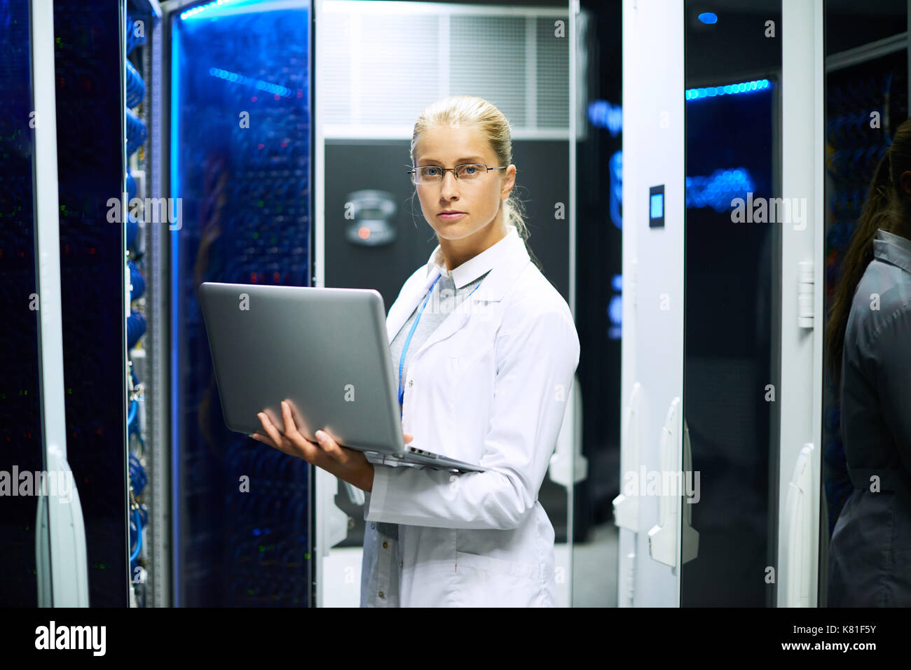 Female Scientist Posing with Supercomputer Stock Photo