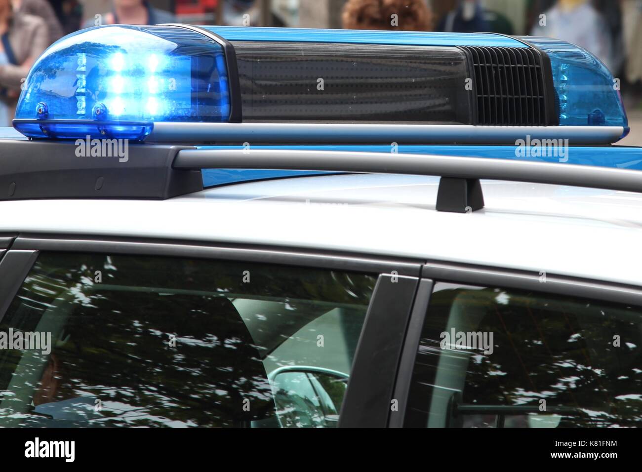 police car with active blue emergency vehicle lighting Stock Photo