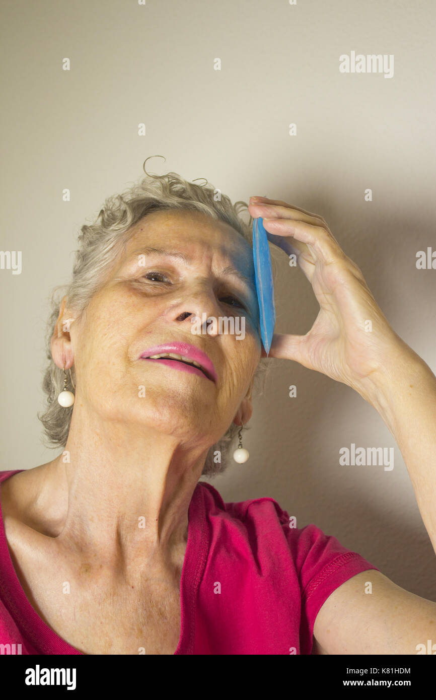 Ice pack for headache in older woman Stock Photo Alamy