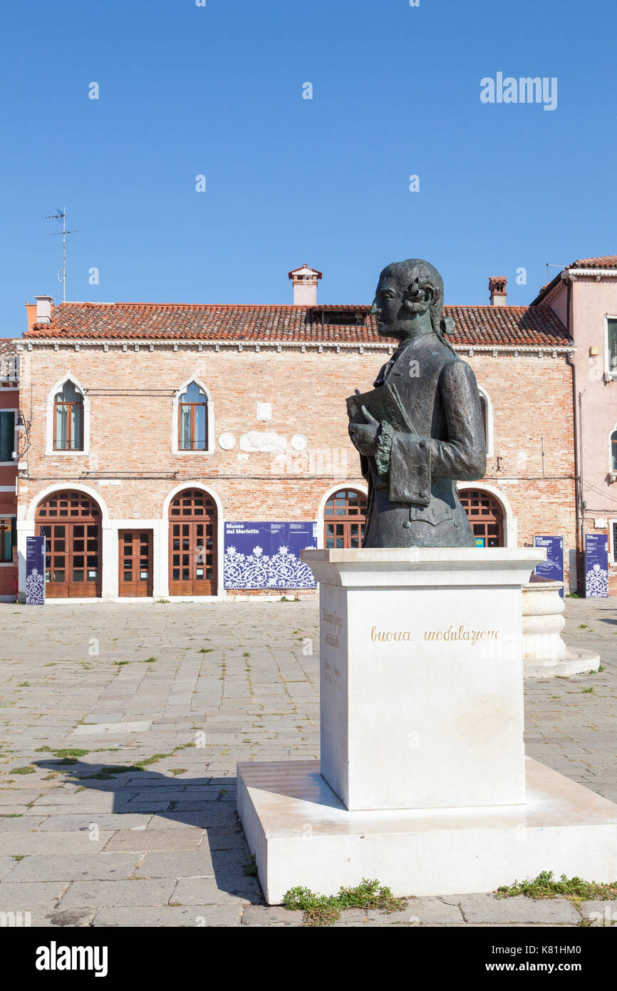 The statue of Baldassare Galuppi in front of the lace museum, Burano, Venice, Italy in Piazza Baldassarre Galuppi. Burano is famous for its historic l Stock Photo