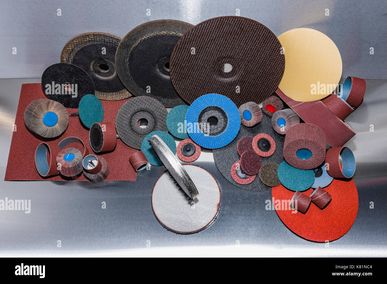 A pile of color abrasive sandpaper for metal working sandpaper for