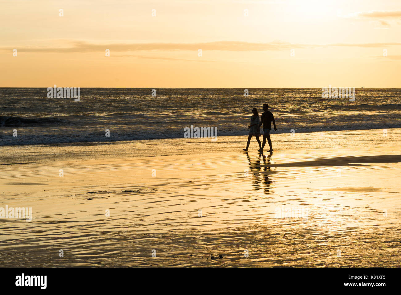 Couple, Man and Woman, Walk on the beach, Sunset, Playa Espadilla, National Park Manuel Antonio, Costa Rica Stock Photo