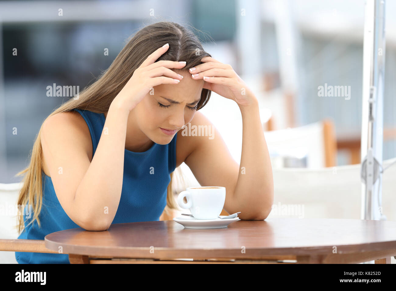 Sad woman complaining sitting in a coffee shop terrace Stock Photo