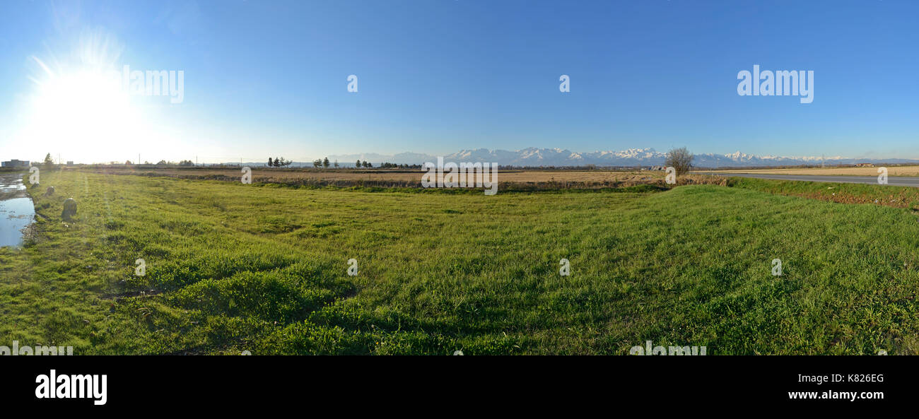 panorama of the Italian countryside of the Po valley, Novara and Vercelli with the background of the mountain range of the Alps Stock Photo