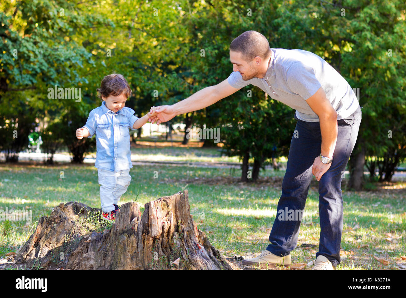 Happy father and son playing in the park Stock Photo