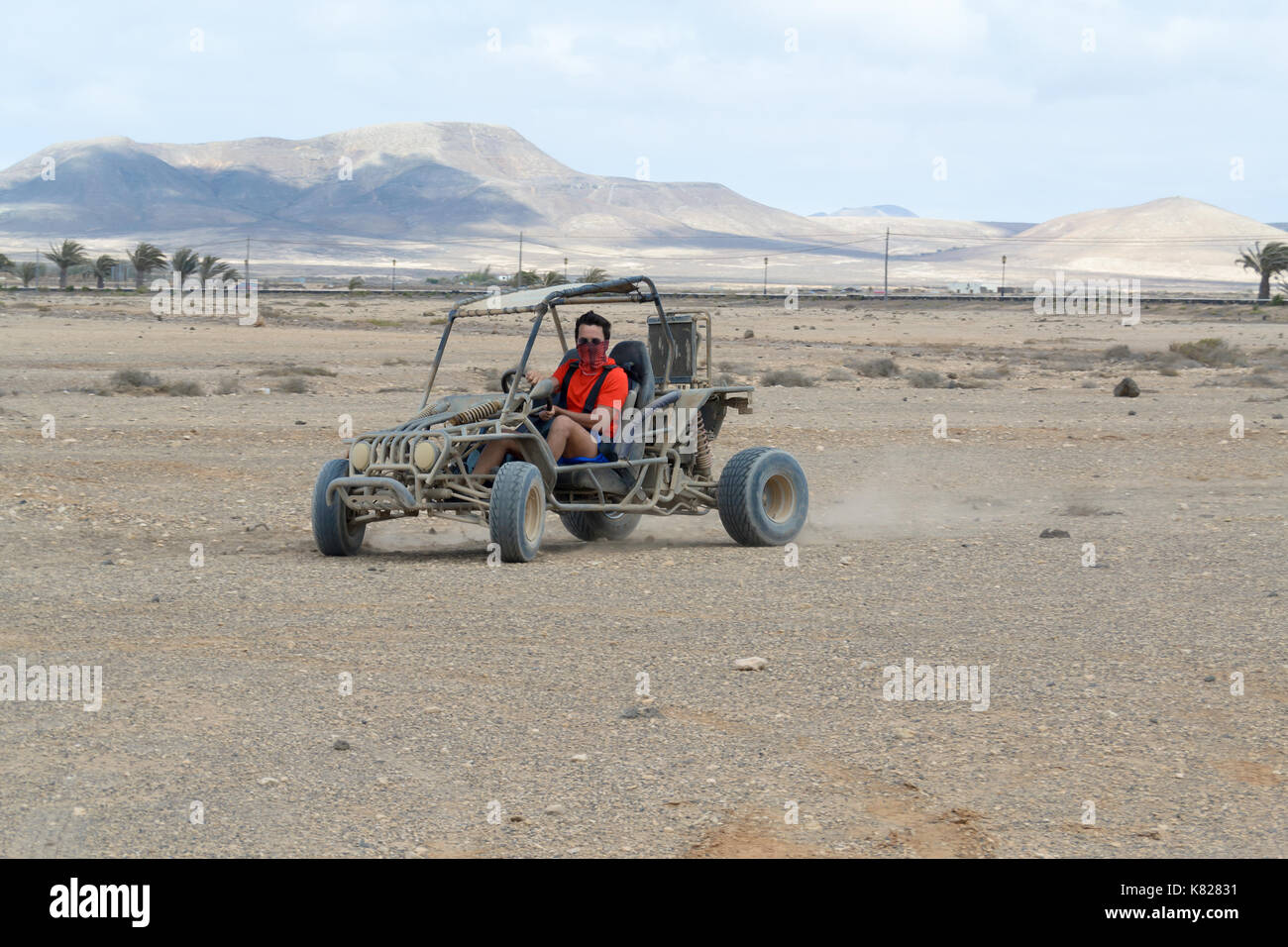 buggy racing on the sand road doing derapage at full speed amidst the desert of Fuerteventura, Canary Stock Photo