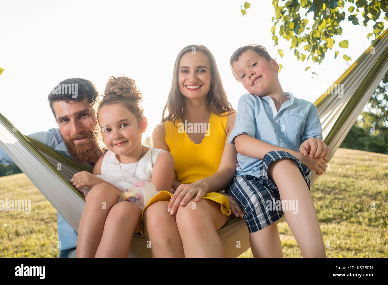 Family portrait with beautiful mother of two children next to he Stock Photo