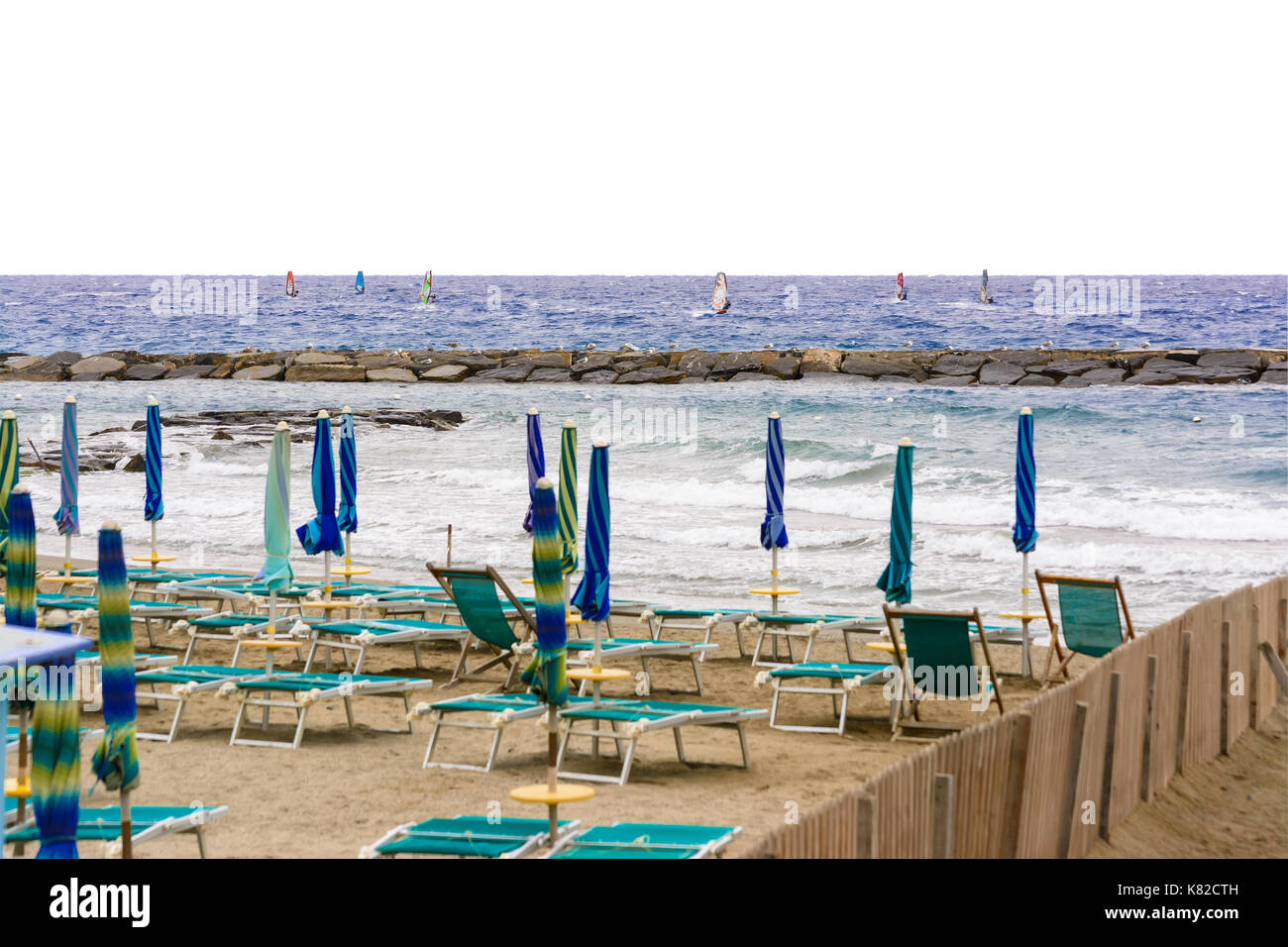 windsurfer that drives its windsurfing speed through the sparkling waves of the Ligurian Sea, in Mediterranean Sea Stock Photo