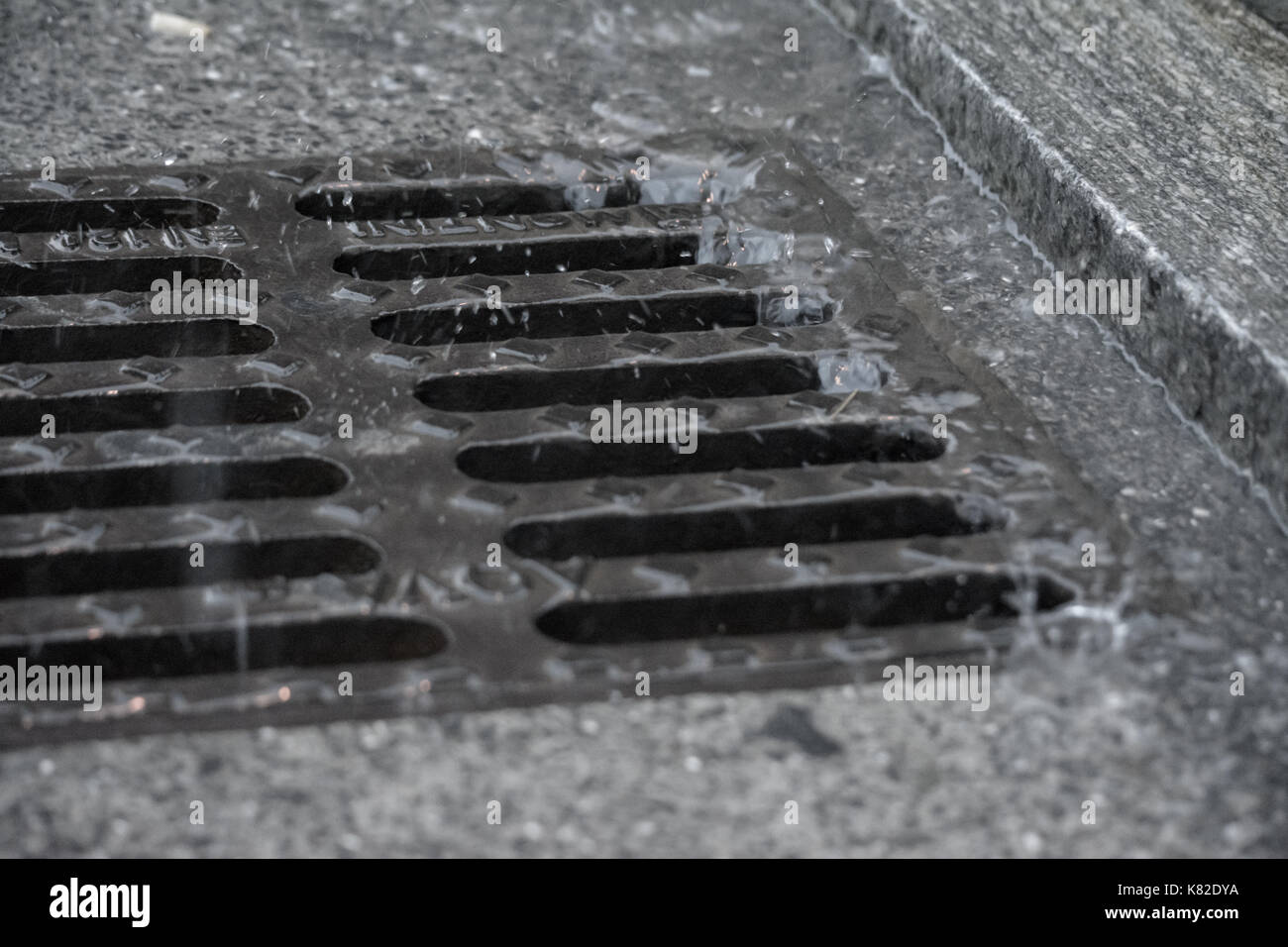 rivers flowing into the road manhole during a day of rain Stock Photo