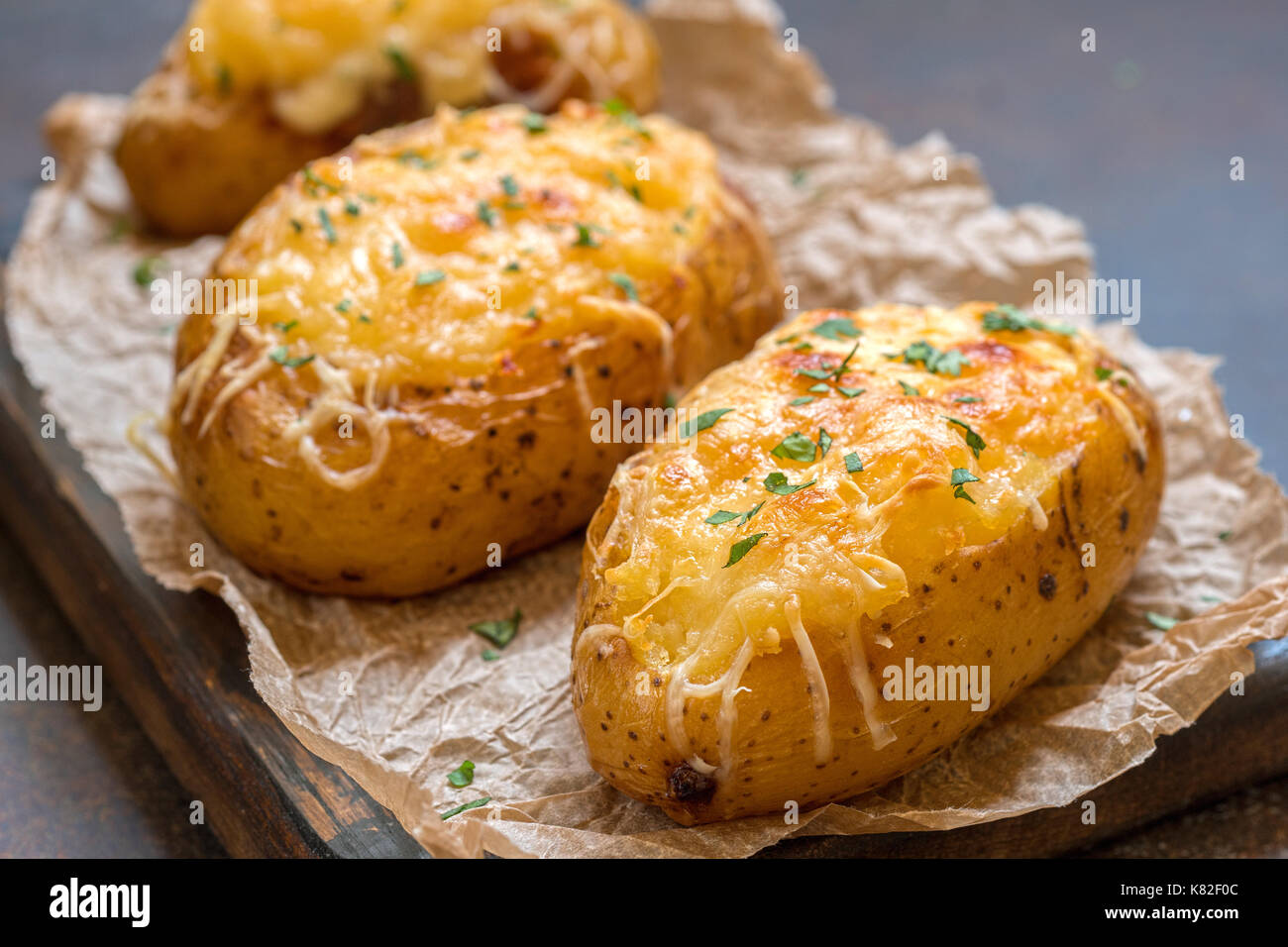 Baked loaded potato with bacon, cheese and onion Stock Photo