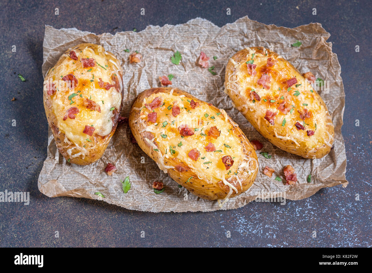 Baked loaded potato with bacon, cheese and onion Stock Photo