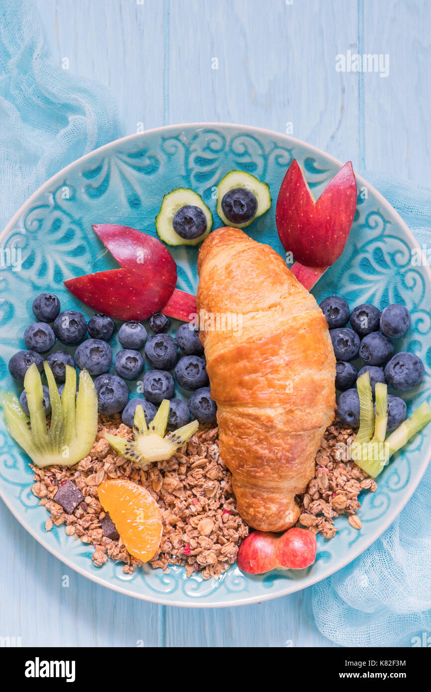 Lobster Croissant with berries for kids breakfast Stock Photo