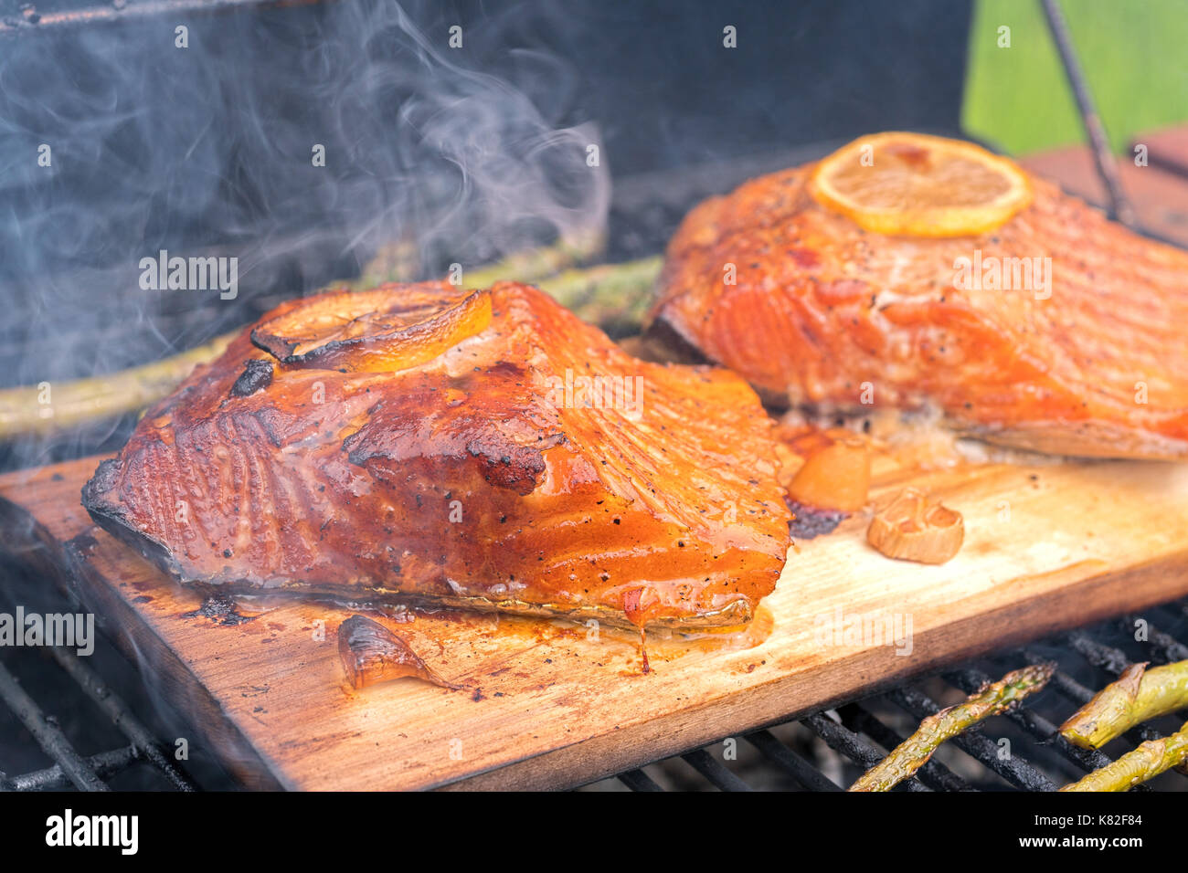 cedar plank salmon with lemon cooking on grill Stock Photo Alamy