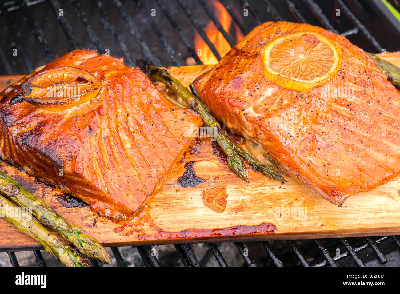 cedar plank salmon with lemon cooking on grill Stock Photo - Alamy