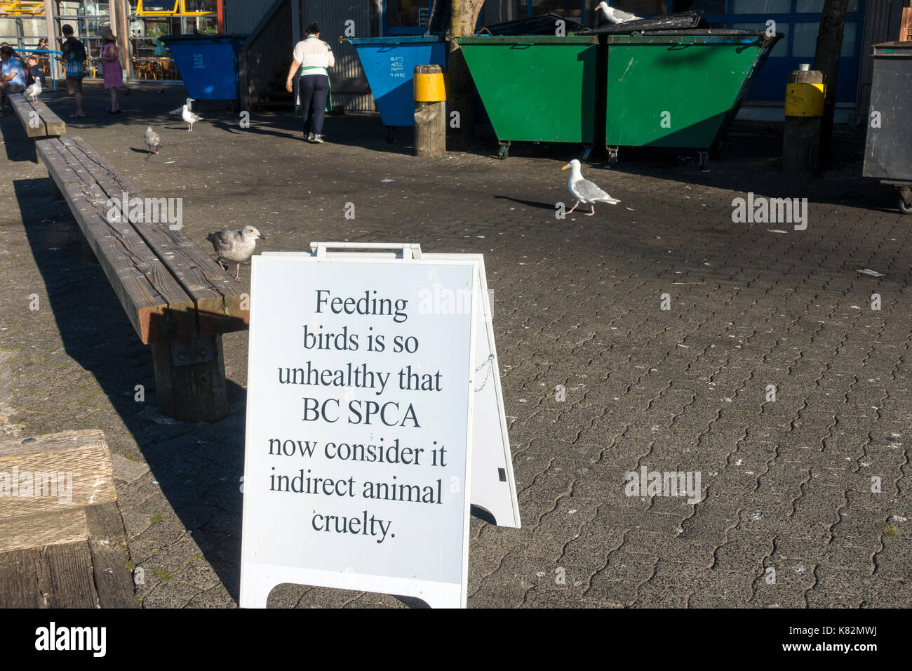A sign on Vancouver's Granville Island informing tourists and visitors that feeding the birds can be considered animal cruelty Stock Photo