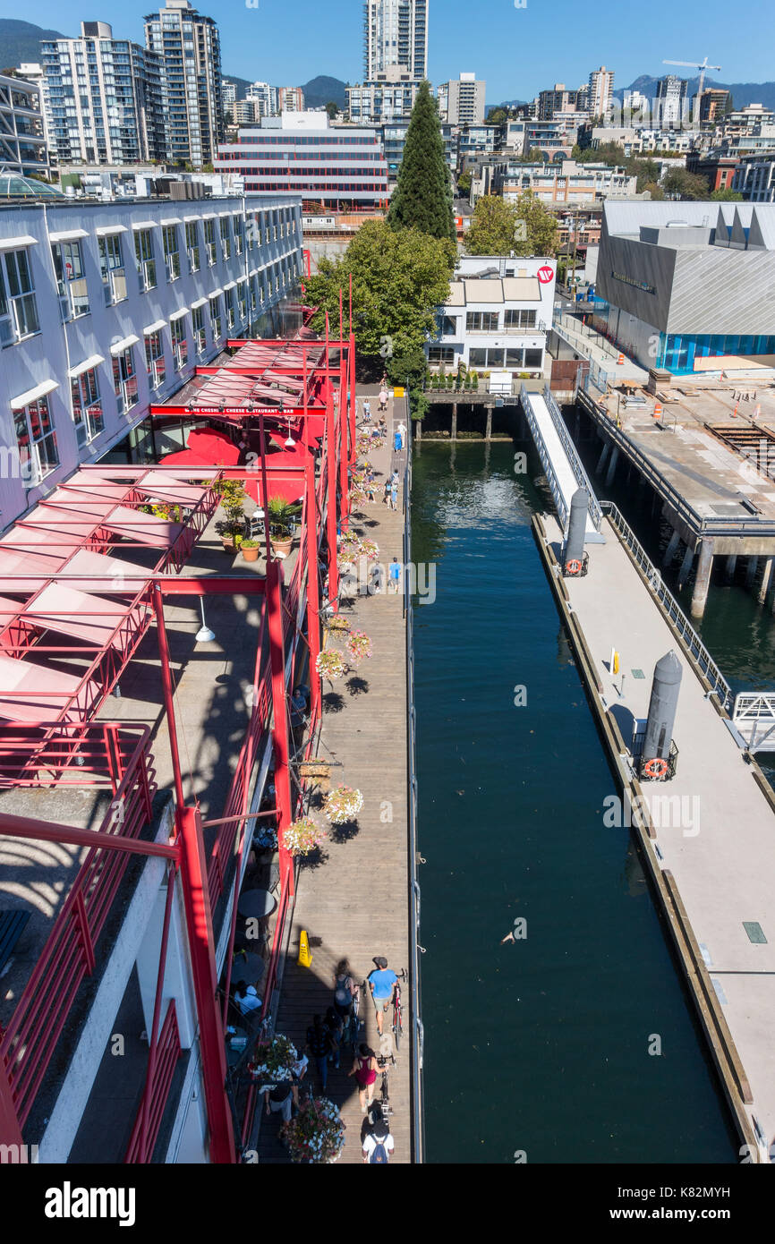 Visitors and pedestrians enjoy the waterside restaurants and bistros at the Lonsdale Quay Market in North Vancouver British Columbia. Stock Photo