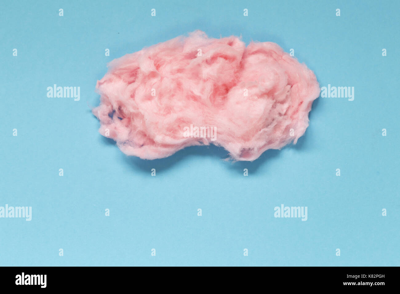 Sweet pink cotton candy on a colored background Stock Photo