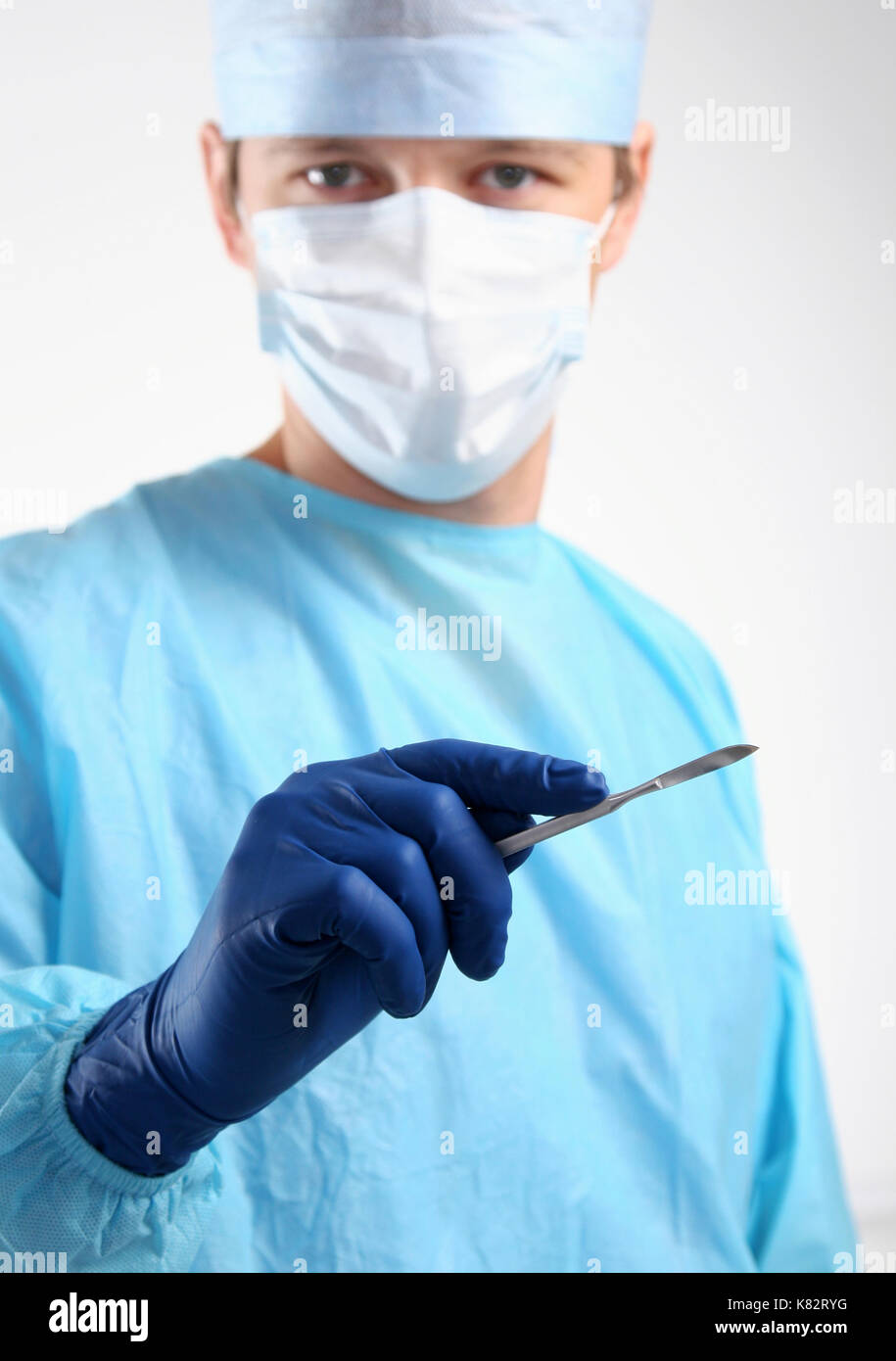 Man surgeon holds a scalpel Stock Photo Alamy