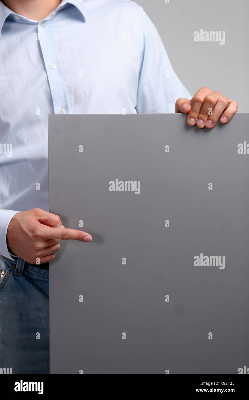 Business Man showing empty space white placard Stock Photo - Alamy